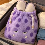 Flump Slipper Pouch packed in a suitcase